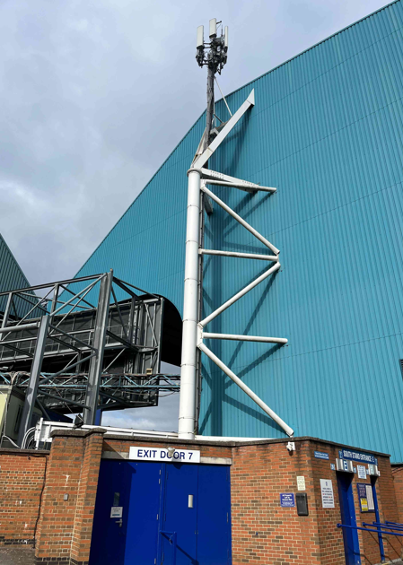 Telecoms equipment beside a stadium structure